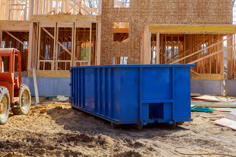 Blue dumpster is located at a construction site for one of our commercial customers.