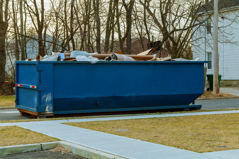 Full dumpster outside a home in Kenosha, WI. They just finished a home clean out project.